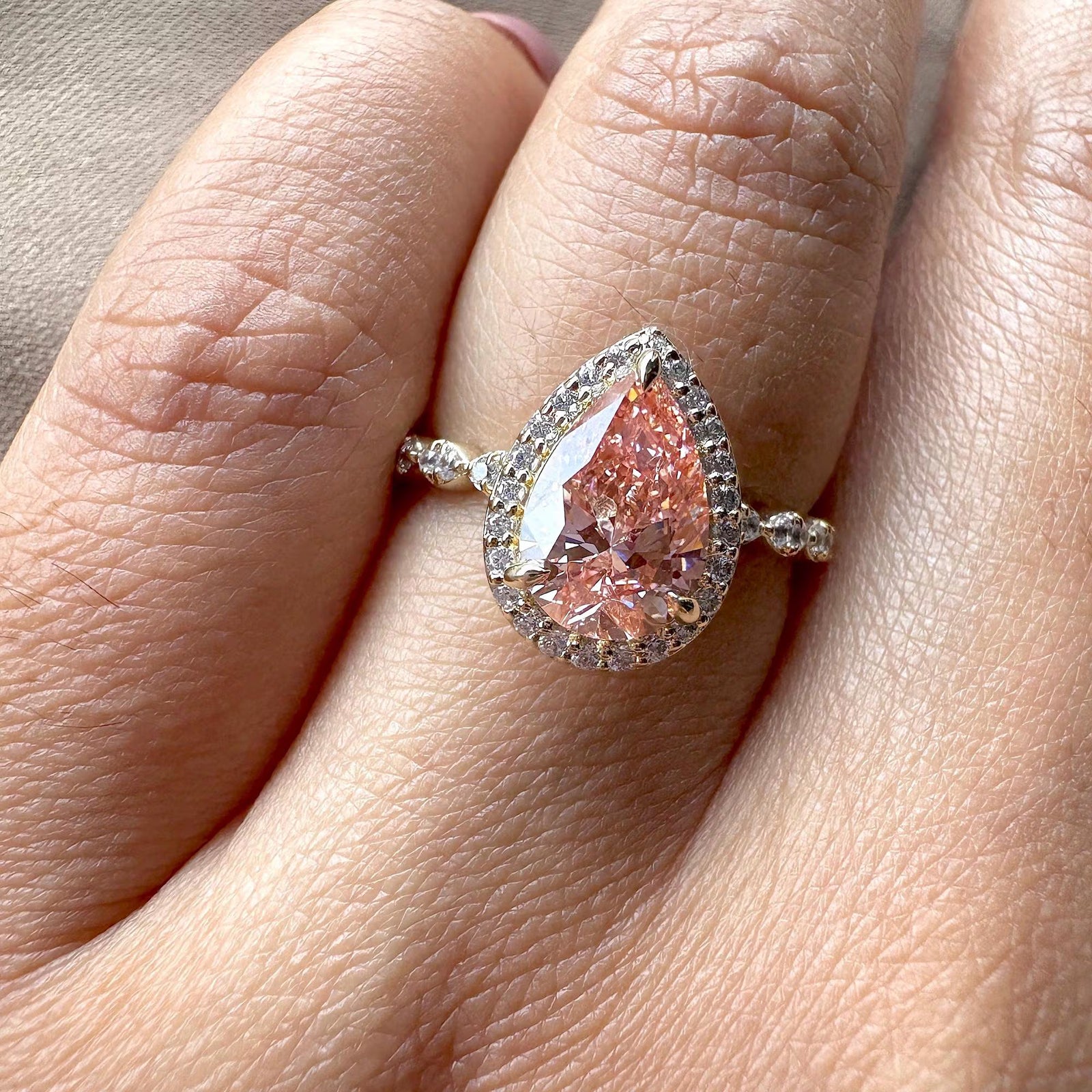 pink pear with pave band, pear cut halo setting, conflict-free pink diamond, pink anniversary ring, pink teardrop engagement ring.