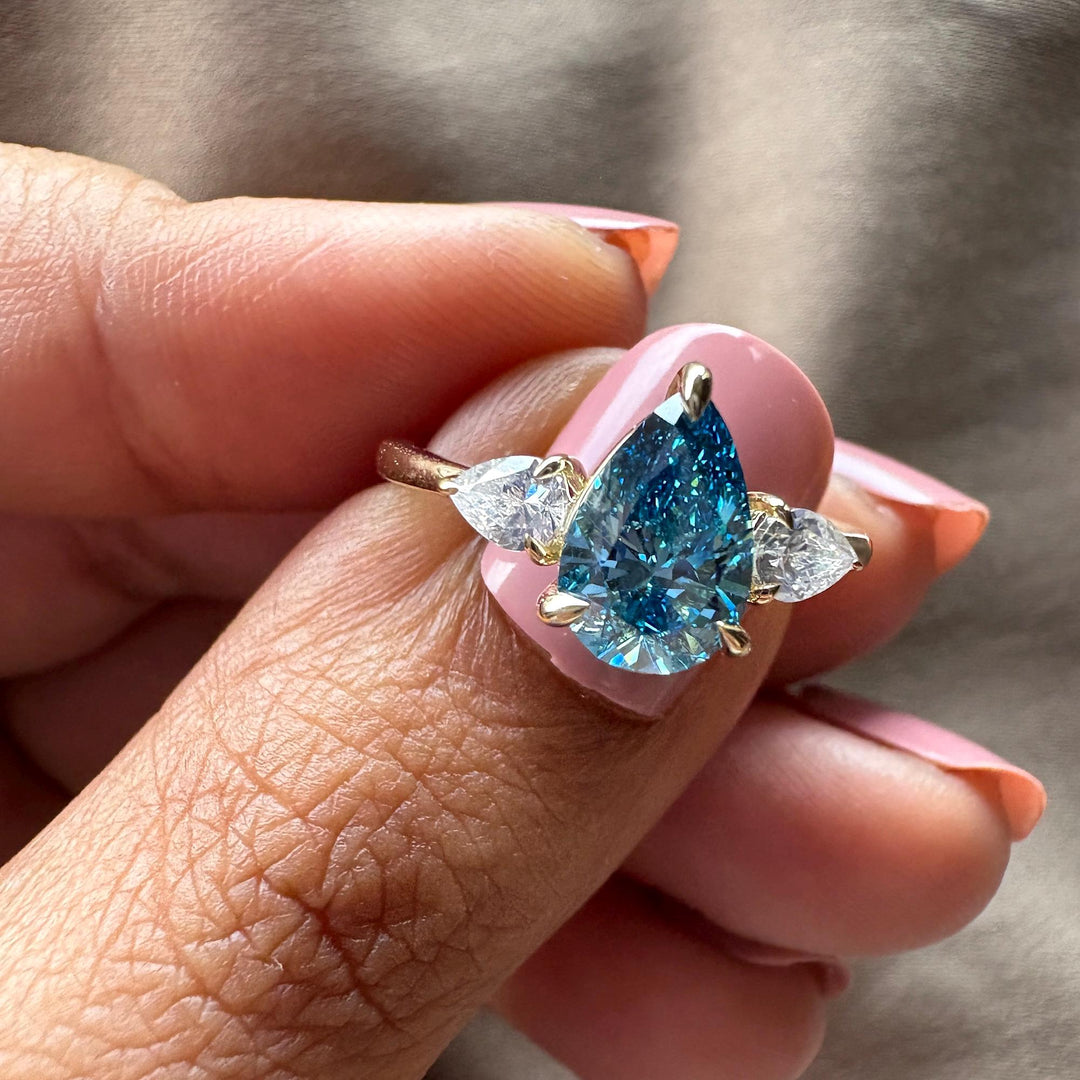  Blue Pear Diamond Aesthetic17. Three Stone Pear Ring Inspiration18. Something Blue Wedding Ring Ideas19. 1.5ct Pear Diamond on Hand20. Triple Pear Cut Engagement Ring