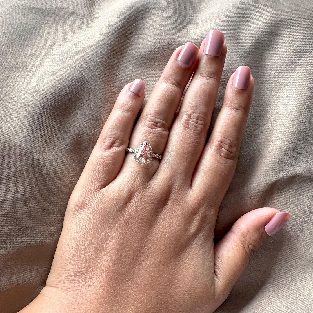 Fancy pink lab diamond, pink pear halo ring, teardrop pink diamond, pink diamond with white halo, 2 carat pear solitaire, sustainable pink diamond, pink and white diamond ring, micro pave engagement ring, fancy vivid pink diamond, pear shaped pink solitaire.