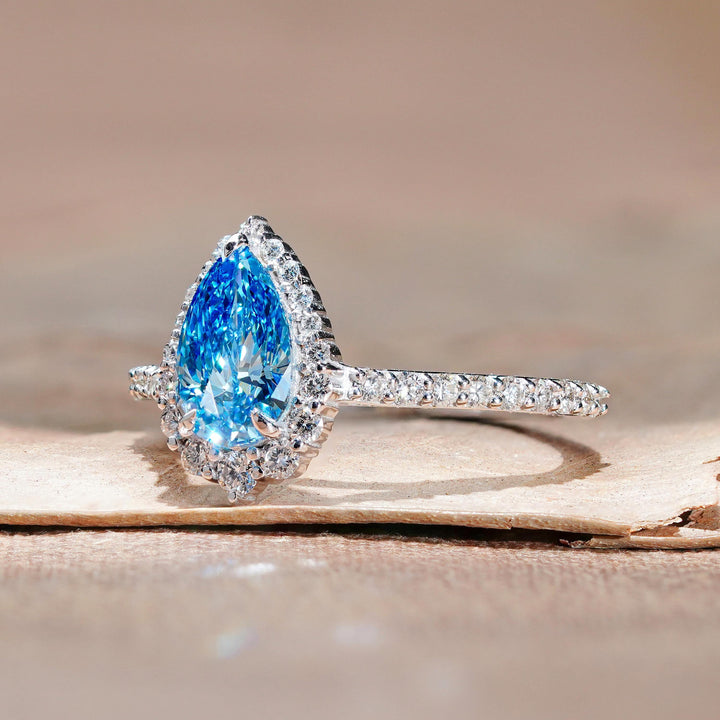 1.5ct Pear Diamond on Hand18. Blue Pear Halo Ring Inspiration19. Something Blue Engagement Ring Ideas20. Dreamy Blue Pear Diamond Ring21. Teal Blue Pear Diamond Aesthetic22. Modern Blue Pear Halo Style