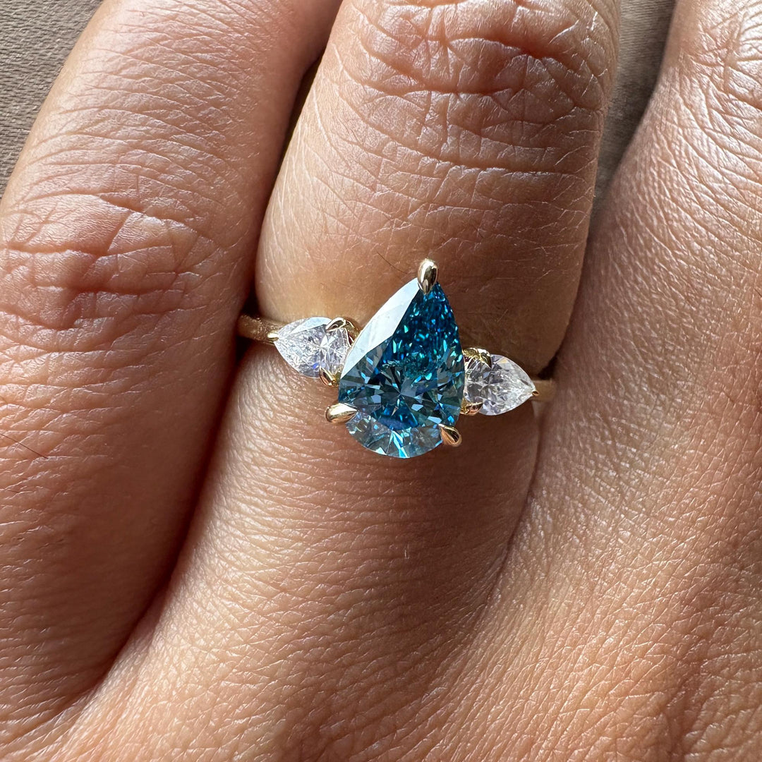  Blue Diamond Trilogy Aesthetic22. Dream Blue Pear Engagement Ring23. Modern Three Stone Blue Diamond24. Blue Pear Diamond with Clear Side Stones25. Unique Anniversary Ring Blue Diamond