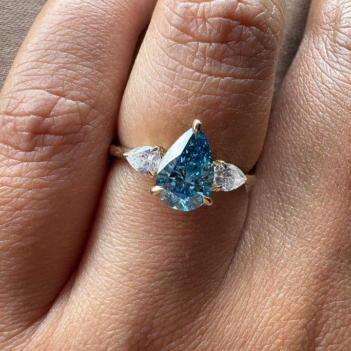  Blue Diamond Trilogy Aesthetic22. Dream Blue Pear Engagement Ring23. Modern Three Stone Blue Diamond24. Blue Pear Diamond with Clear Side Stones25. Unique Anniversary Ring Blue Diamond