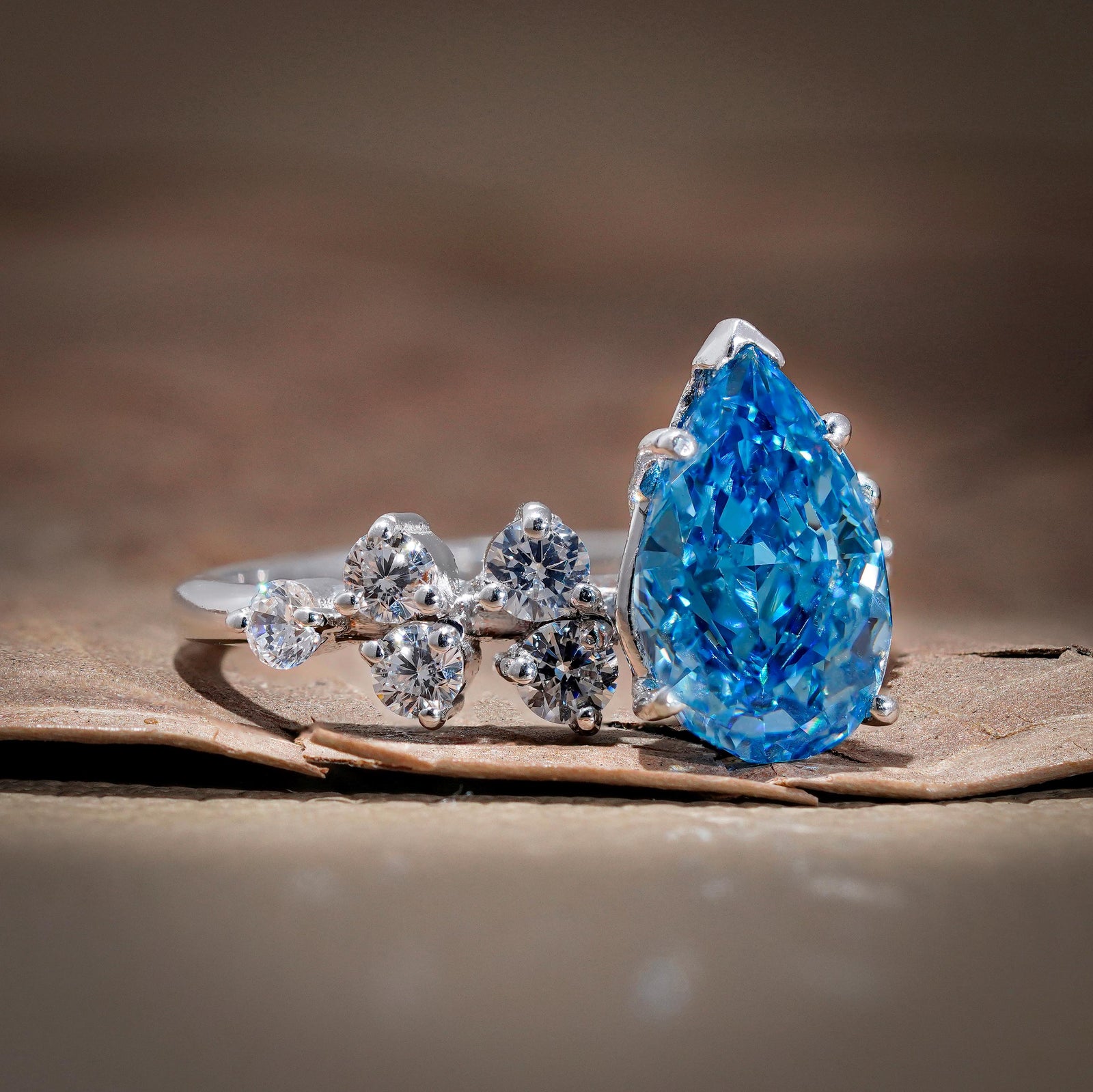 vvs blue lab diamond, blue diamond with white diamond halo, pear cluster setting, blue teardrop halo, conflict-free blue diamond, blue anniversary ring, 3 carat pear cluster.
