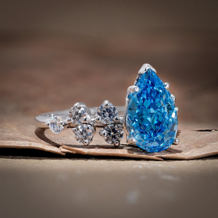 vvs blue lab diamond, blue diamond with white diamond halo, pear cluster setting, blue teardrop halo, conflict-free blue diamond, blue anniversary ring, 3 carat pear cluster.