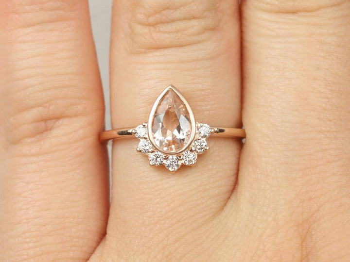 blush pink engagement ring pear
pear rose pink ring
soft peach engagement ring
pear cut pink gemstone ring