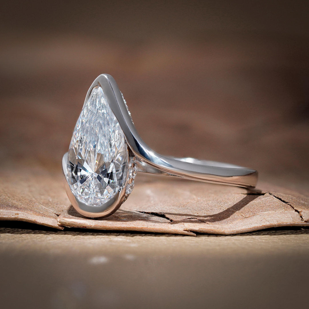 pear cut bypass ring, sustainable bridal jewelry, curved band engagement ring, 2 carat pear solitaire