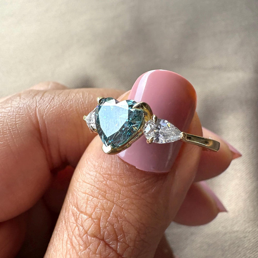 Blue heart diamond halo, heart cut lab diamond, fancy blue diamond ring, three stone heart ring, teardrop side stones, blue and white diamond ring, romantic heart jewelry, heart shaped anniversary ring, blue diamond trilogy, sustainable heart ring.